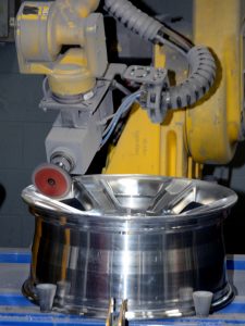 Robot buffing a chrome wheel