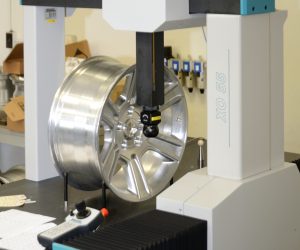Coordinate Measuring Machine with machined aluminum wheel loaded for measurement