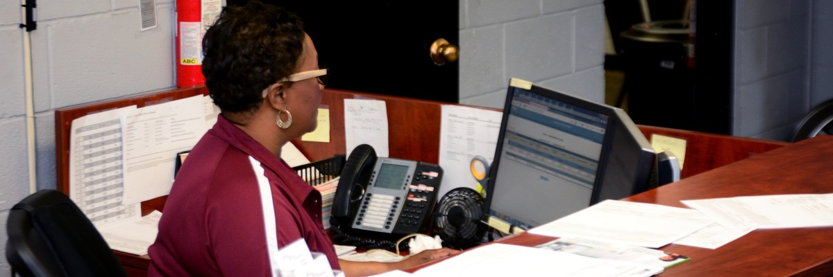 AMT office manager working at her desk